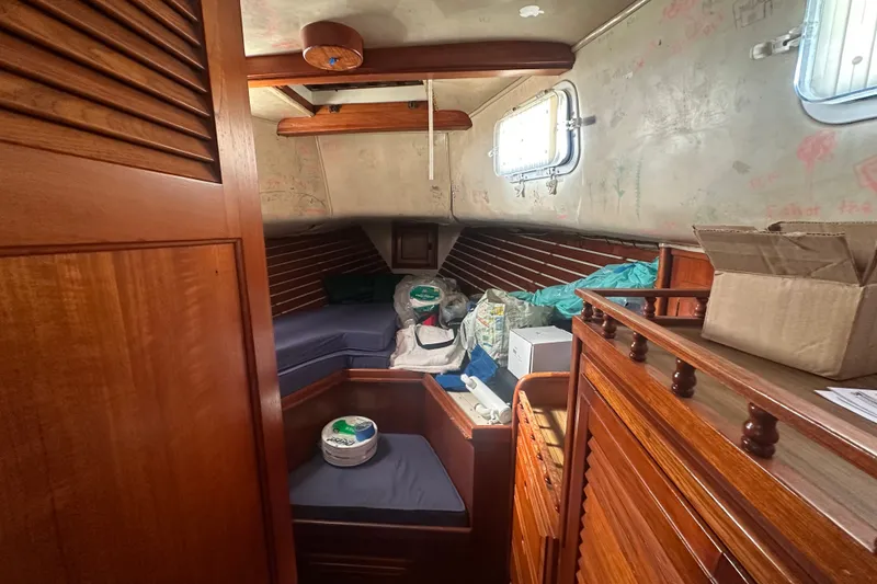 Slide: The Image of Cozy cabin interior of 1977 DownEaster 45 yacht with wooden furnishings and storage. - 25