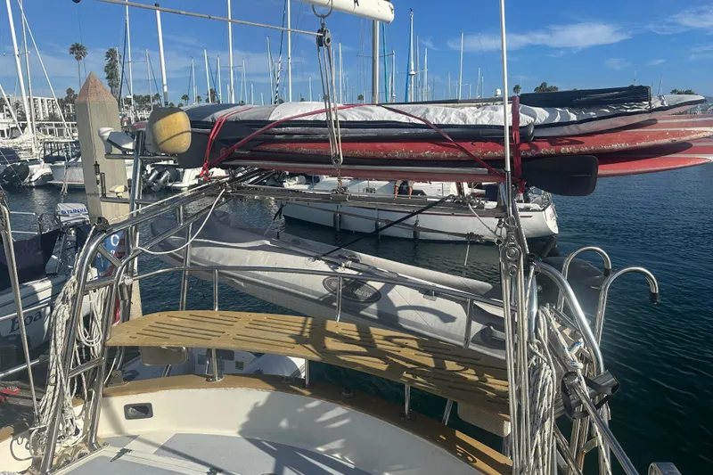 Slide: The Image of 1977 Down East Yachts DownEaster 45 sailboat with paddleboards, docked in a marina. - 15