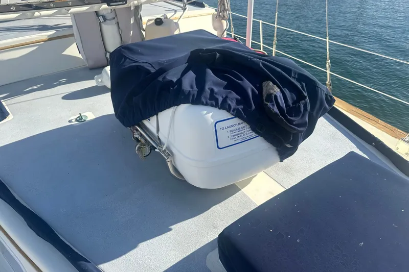 Slide: The Image of Deck of 1977 DownEaster 45 yacht with covered equipment and ocean view. - 11