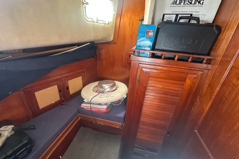 Slide: The Image of 1977 Down East Yachts DownEaster 45 cabin interior with wooden cabinetry and seating area. - 29