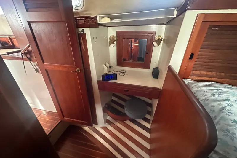 Slide: The Image of 1977 DownEaster 45 yacht interior with wooden cabinetry and cozy vanity area. - 28
