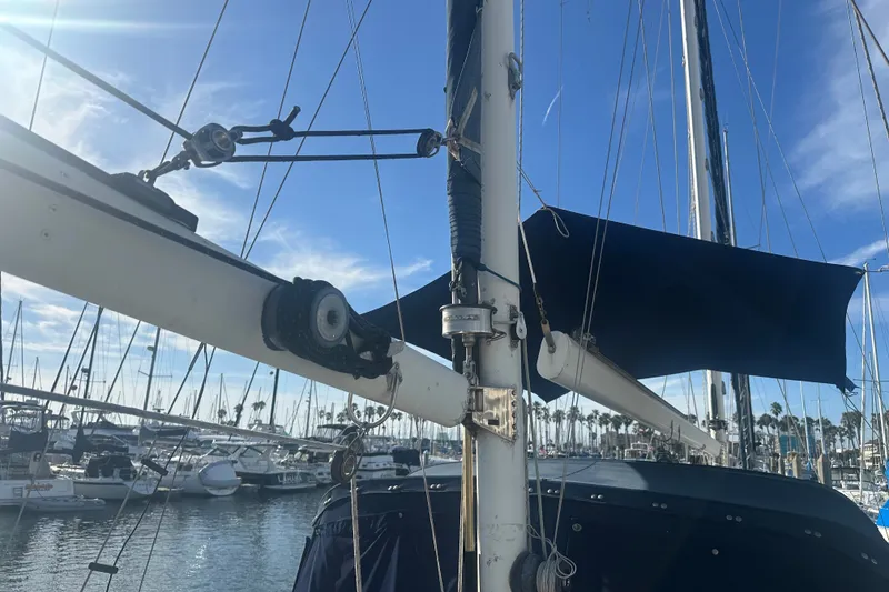 Slide: The Image of 1977 Down East Yachts DownEaster 45 sailboat mast and rigging in a marina setting. - 16