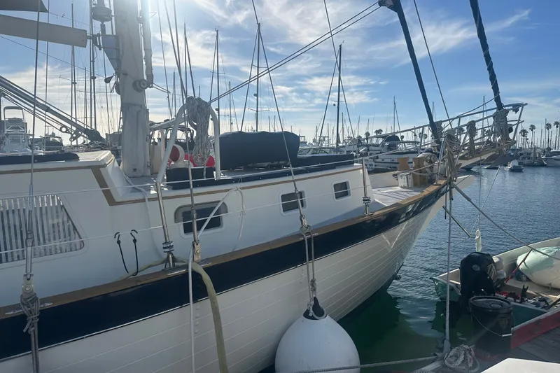 Slide: The Image of 1977 Down East Yachts DownEaster 45 sailboat docked in a sunny marina. - 7