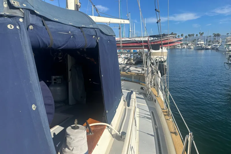 Slide: The Image of 1977 Down East Yachts DownEaster 45 sailboat docked in a sunny marina. - 13