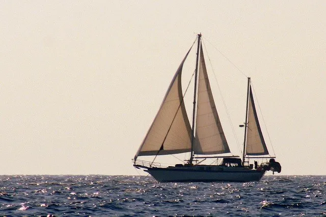 Slide: The Image of 1977 Down East Yachts DownEaster 45 sailboat cruising on open sea at sunset. - 3