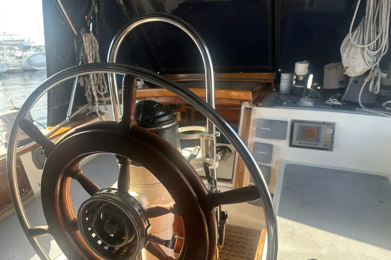 Slide: The Image of Steering wheel of a 1977 Down East Yachts DownEaster 45 sailboat, with nautical equipment. - 19