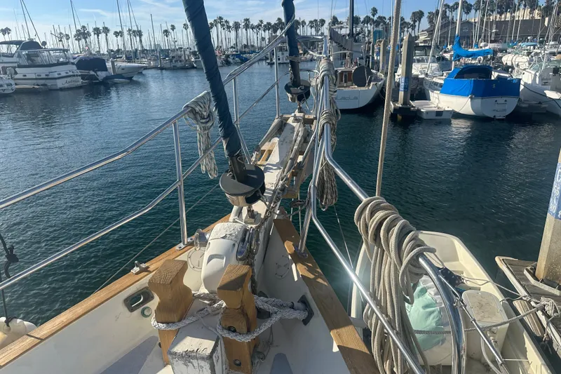 Slide: The Image of 1977 Down East Yachts DownEaster 45 sailboat docked in a marina with other boats. - 9