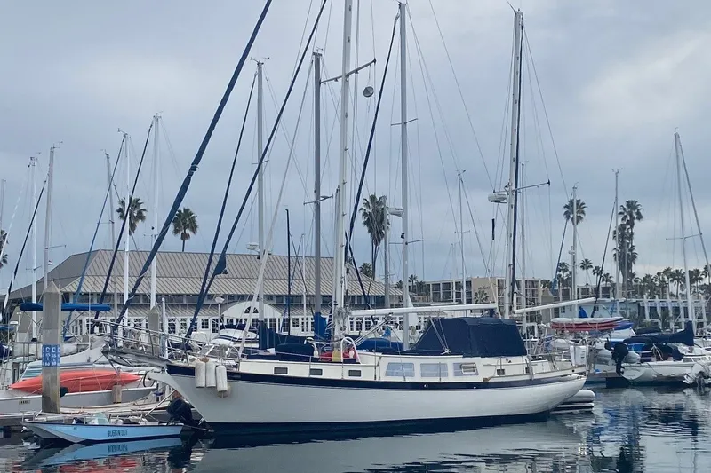 Slide: The Image of 1977 Down East Yachts DownEaster 45 sailboat docked in a marina. - 5