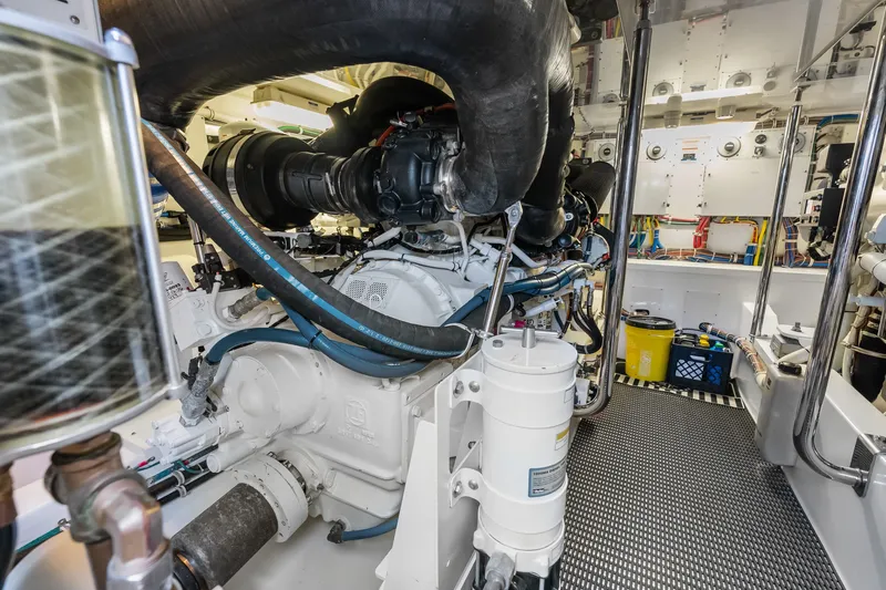 Slide: The Image of Engine room of 2017 Hatteras GT54 yacht, showcasing complex machinery and components. - 80