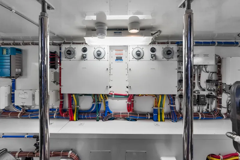 Slide: The Image of Engine room of 2017 Hatteras GT54 yacht with electrical panels and wiring. - 83