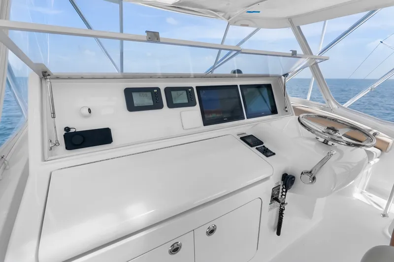 Slide: The Image of Helm of 2017 Hatteras GT54 yacht with modern navigation equipment and ocean view. - 23