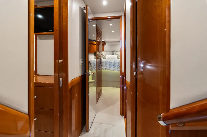 Slide: The Image of Luxurious interior of 2017 Hatteras GT54 yacht, featuring polished wood and elegant bedroom. - 50