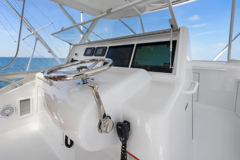 Slide: The Image of Helm of 2017 Hatteras GT54 yacht with steering wheel and navigation screens. - 22