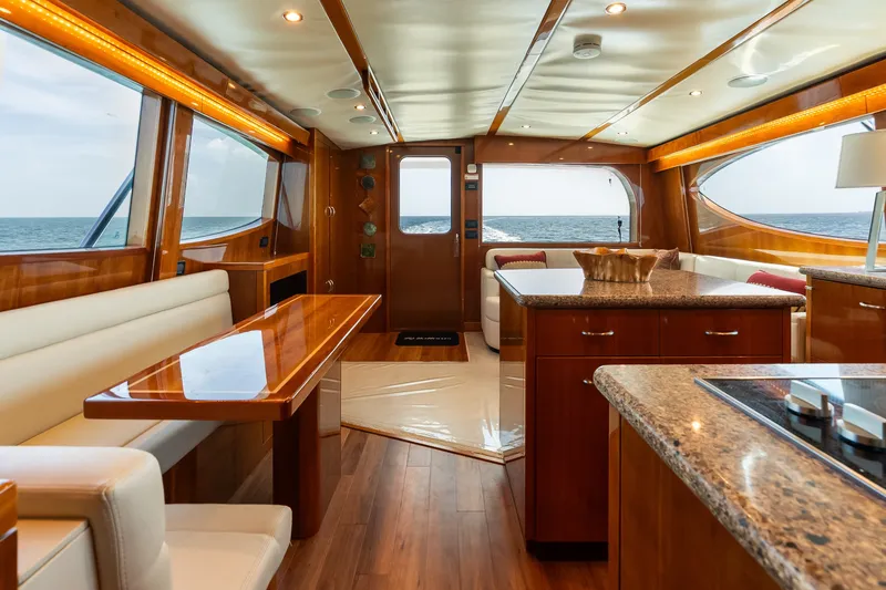 Slide: The Image of Luxurious interior of 2017 Hatteras GT54 yacht with elegant wood finishes and ocean view. - 47