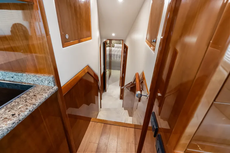 Slide: The Image of Luxurious interior of 2017 Hatteras GT54 yacht with polished wood and granite finishes. - 49