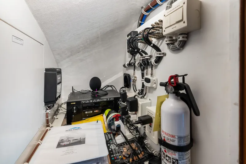 Slide: The Image of Electrical equipment and fire extinguisher in 2017 Hatteras GT54 yacht control room. - 76
