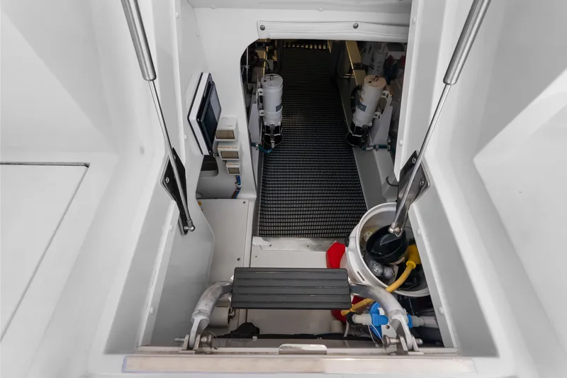 Slide: The Image of Engine room entrance of 2017 Hatteras GT54 yacht, showcasing equipment and access steps. - 77