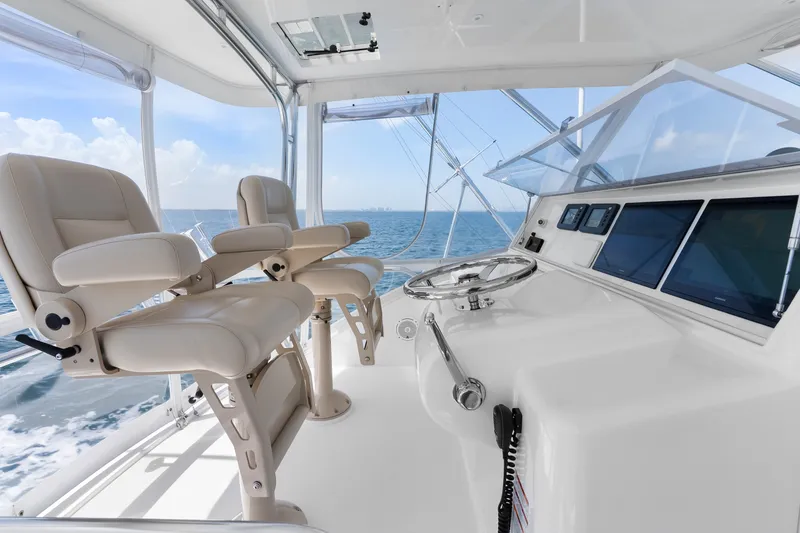 Slide: The Image of Luxurious helm of 2017 Hatteras GT54 yacht with leather seats and ocean view. - 25