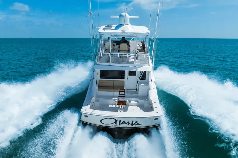 Slide: The Image of 2017 Hatteras GT54 yacht cruising swiftly on open blue ocean waters. - 14