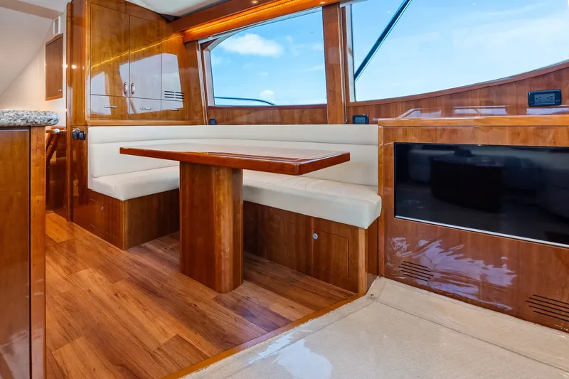 Slide: The Image of Luxurious interior of 2017 Hatteras GT54 yacht with wood finishes and seating area. - 40