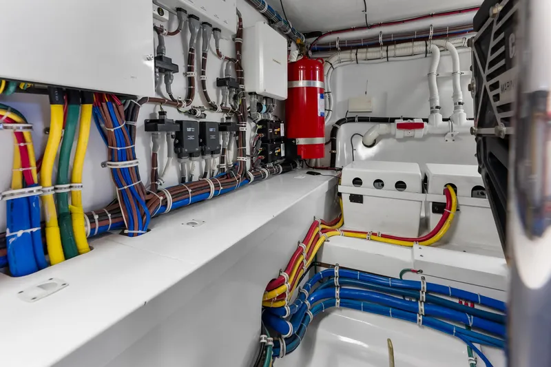 Slide: The Image of Engine room of 2017 Hatteras GT54 yacht with organized wiring and equipment. - 85