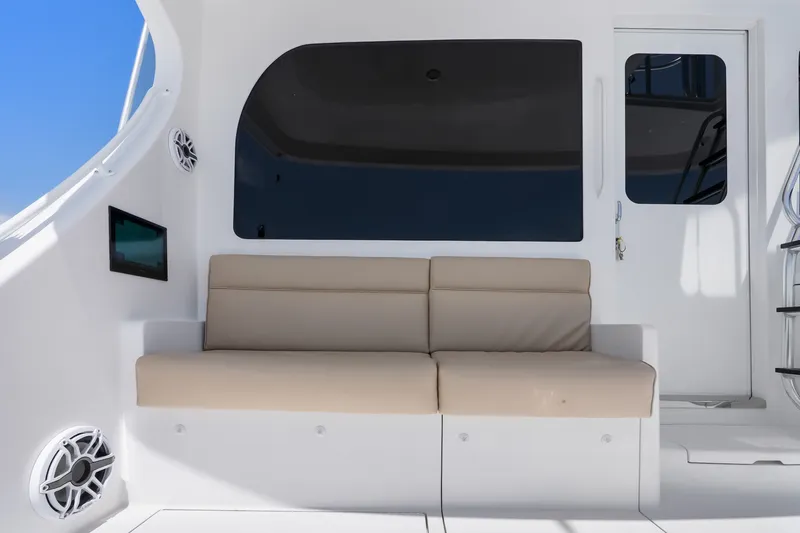 Slide: The Image of 2017 Hatteras GT54 yacht interior with beige seating, sleek design, and modern amenities. - 36