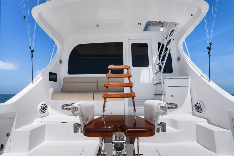Slide: The Image of 2017 Hatteras GT54 yacht interior with seating and ladder, under clear blue sky. - 34