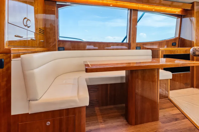 Slide: The Image of Luxurious interior of 2017 Hatteras GT54 yacht with elegant wood finish and plush seating. - 46
