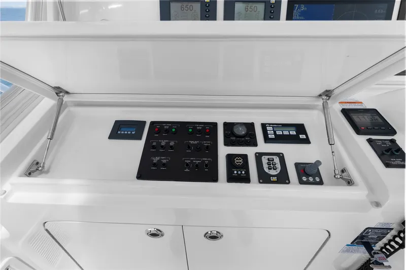 Slide: The Image of Control panel of 2017 Hatteras GT54 yacht with various navigation instruments and displays. - 27