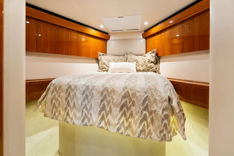 Slide: The Image of Luxurious cabin interior of 2017 Hatteras GT54 yacht with elegant bedding and wood cabinetry. - 66