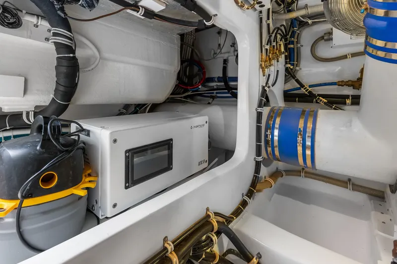 Slide: The Image of Engine room of 2017 Hatteras GT54 yacht with mechanical components and wiring. - 82