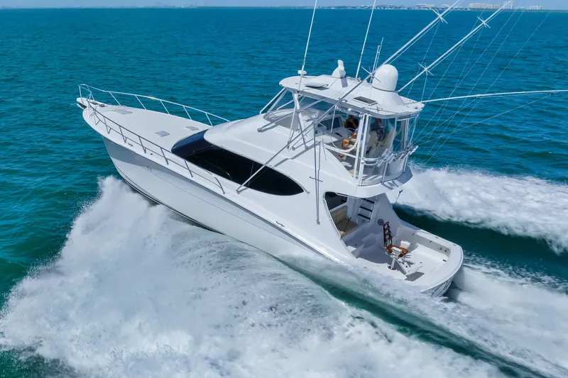 Slide: The Image of 2017 Hatteras GT54 yacht cruising on open blue waters. - 18