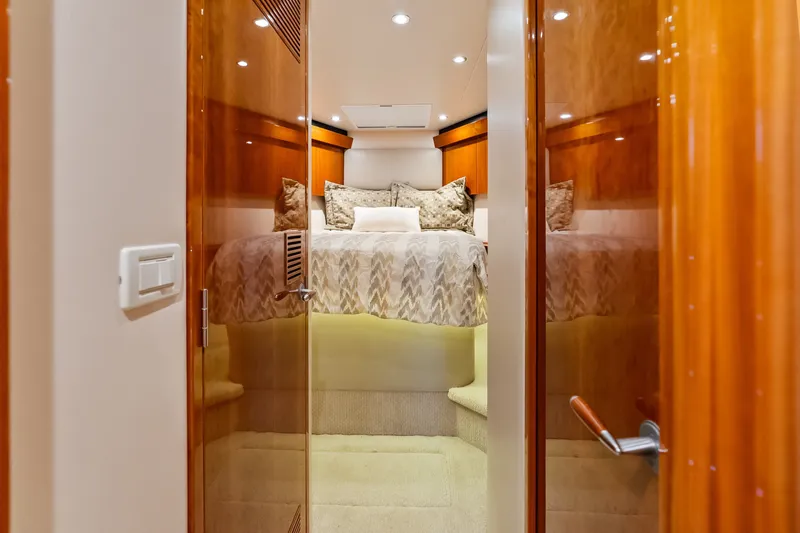 Slide: The Image of Luxurious cabin interior of 2017 Hatteras GT54 yacht with elegant bedding and wood finishes. - 68
