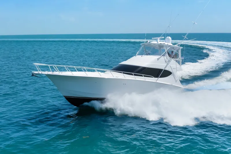 Slide: The Image of 2017 Hatteras GT54 yacht cruising swiftly on open blue waters. - 19