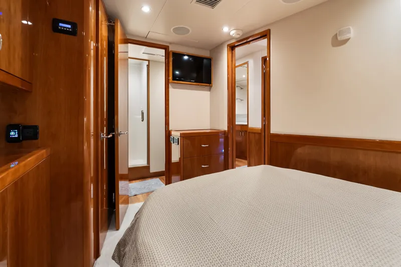 Slide: The Image of Luxurious interior of 2017 Hatteras GT54 yacht bedroom with wood finishes and modern amenities. - 53