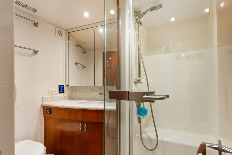 Slide: The Image of Luxurious bathroom in 2017 Hatteras GT54 yacht with modern fixtures and elegant design. - 63