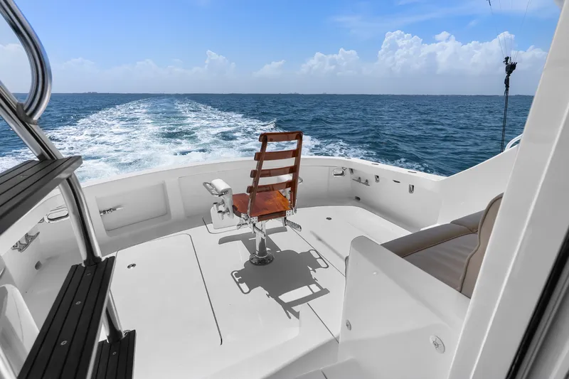 Slide: The Image of 2017 Hatteras GT54 yacht deck with ocean view and fishing chair. - 35