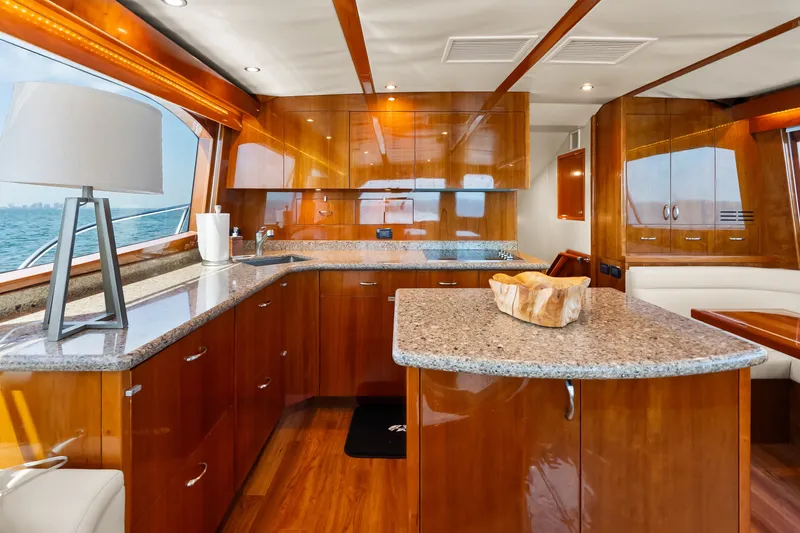 Slide: The Image of Luxurious interior of 2017 Hatteras GT54 yacht with elegant wood finishes and modern kitchen. - 43