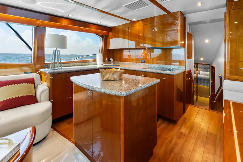 Slide: The Image of Luxurious 2017 Hatteras GT54 yacht interior with elegant wood finishes and ocean view. - 44