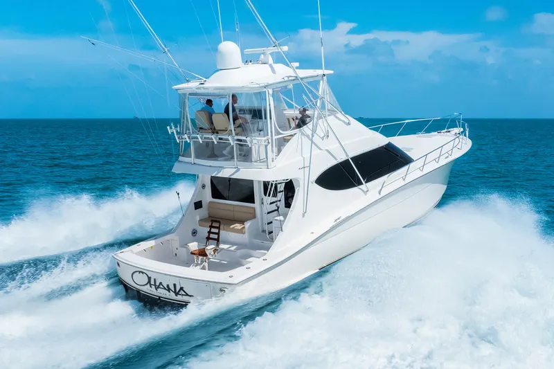 Slide: The Image of 2017 Hatteras GT54 yacht cruising on open ocean waters. - 13