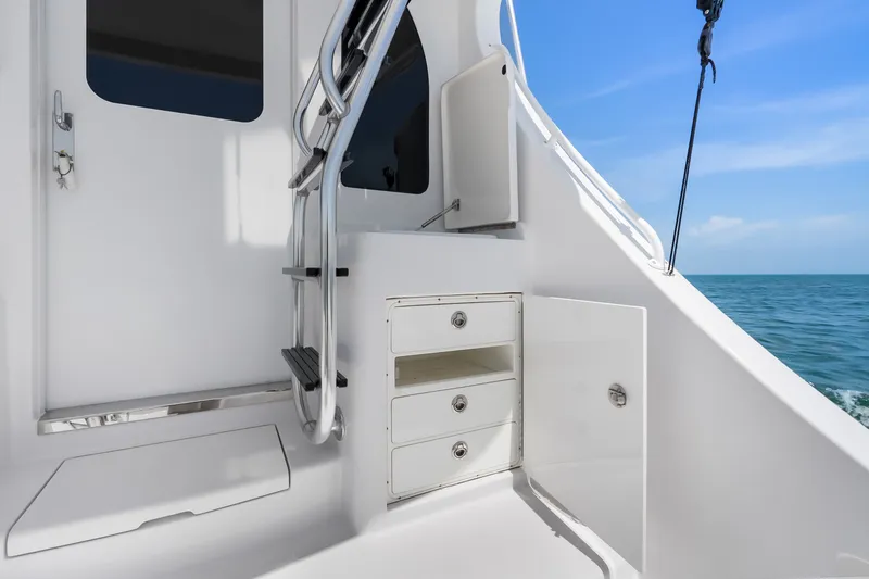 Slide: The Image of 2017 Hatteras GT54 yacht interior with storage drawers and ocean view. - 38