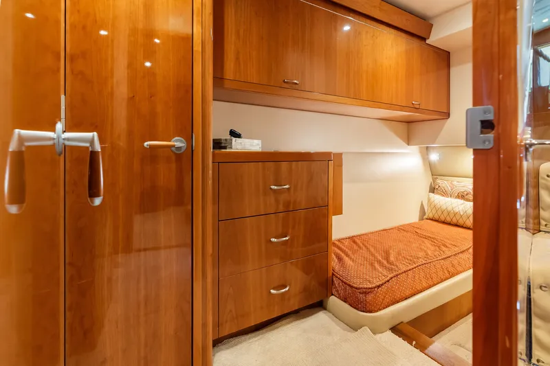 Slide: The Image of Luxurious cabin interior of 2017 Hatteras GT54 yacht with wooden cabinetry and cozy bed. - 62