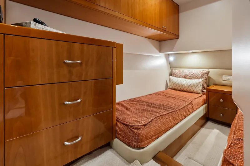 Slide: The Image of 2017 Hatteras GT54 yacht cabin with wooden cabinetry and cozy single bed. - 59