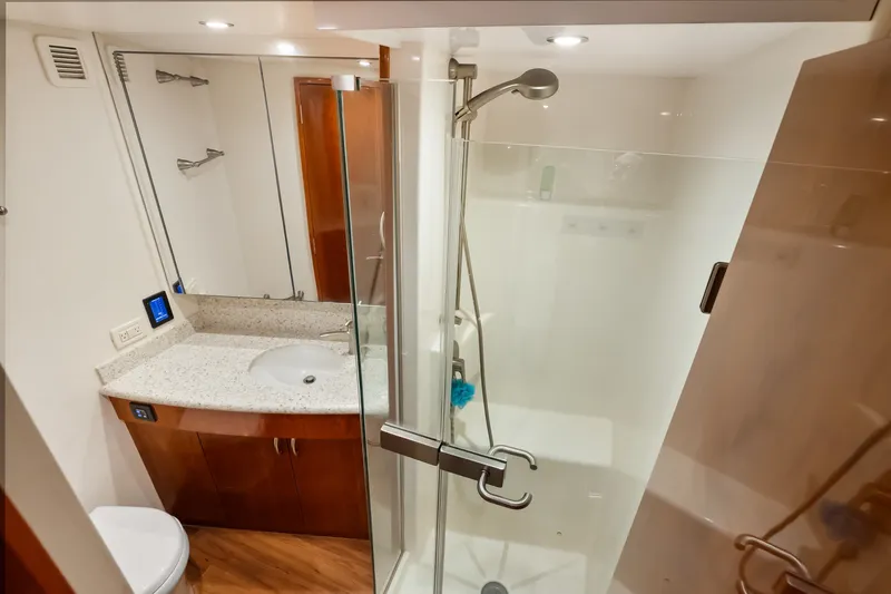 Slide: The Image of Luxurious bathroom in 2017 Hatteras GT54 yacht with modern shower and sleek vanity. - 64
