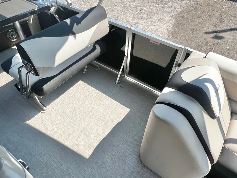 Slide: The Image of The image shows the interior of an Avalon LSZ 25' Entertainer pontoon boat with sleek seating. - 12