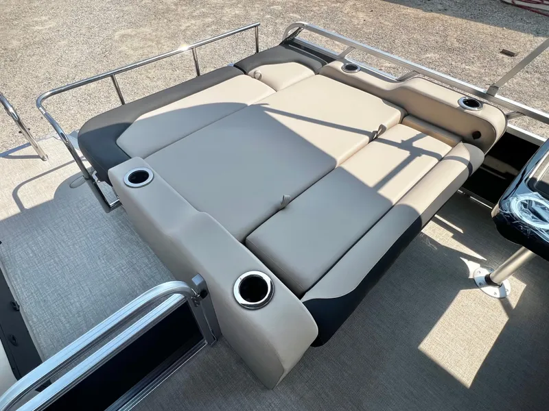 Slide: The Image of The image shows a lounging area on a boat with beige cushions and cup holders. - 18