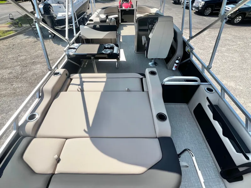 Slide: The Image of The image shows the deck of a 2027 Avalon LSZ 25' Entertainer with beige upholstery and a table. - 19