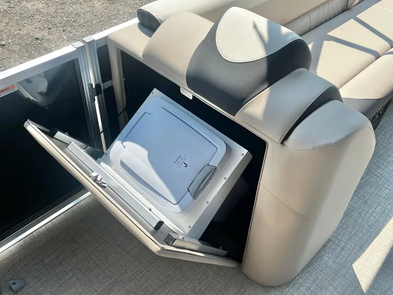 Slide: The Image of A modern refrigerator is integrated into a boat's seating area, surrounded by beige upholstery. - 25