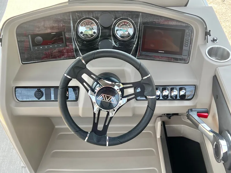 Slide: The Image of The image shows the helm of an Avalon LSZ 25' Entertainer with modern gauges and a sleek steering wheel. - 23