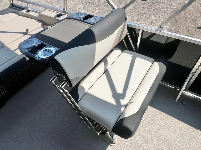 Slide: The Image of A sleek seat with black and white upholstery and an integrated table on a boat. - 21